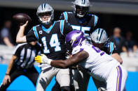 Minnesota Vikings defensive tackle Dalvin Tomlinson (94) chases Carolina Panthers quarterback Sam Darnold (14) during the first half of an NFL football game, Sunday, Oct. 17, 2021, in Charlotte, N.C. (AP Photo/Jacob Kupferman)