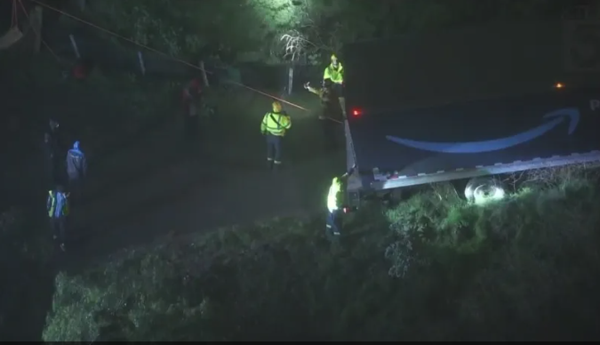 A delivery truck is perched precariously on the side of a hill near Montecito Heights on Monday night.