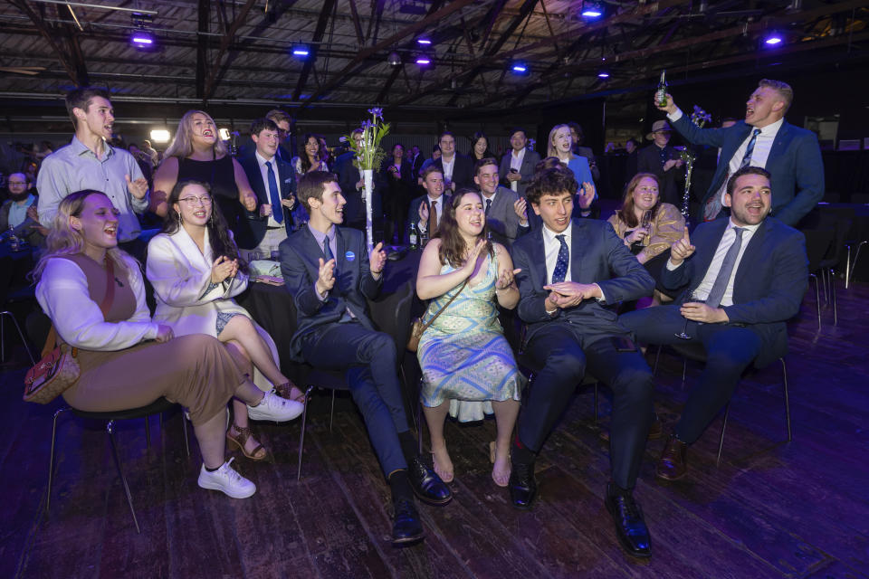 New Zealand National Party supporters cheer as preliminary results are announced at a party event in Auckland, Saturday, Oct. 14, 2023, following a general election.(AP Photo/Brett Phibbs)