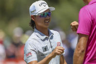 Australia's Min Woo Lee reacts after making an eagle on the first hole during the Australian Open golf championship at Victoria golf course in Melbourne, Australia, Sunday, Dec. 4, 2022. (AP Photo/Asanka Brendon Ratnayake)