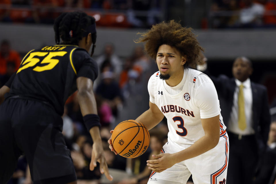 Auburn guard Tre Donaldson (3) dribbles the ball as Missouri guard Sean East II (55) defends during the second half of an NCAA college basketball game, Tuesday, Feb. 14, 2023, in Auburn, Ala. (AP Photo/Butch Dill)