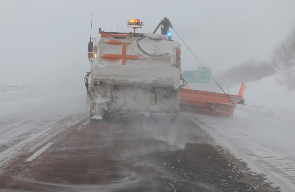 A plow clears U.S. 80 as a snowy and freezing cold weather system passes through Des Moines, Iowa, on Jan. 13, 2024. The weather system is bringing snowfall and subzero temperatures to Iowa as caucusgoers prepare for the Republican presidential caucuses on Jan. 15.