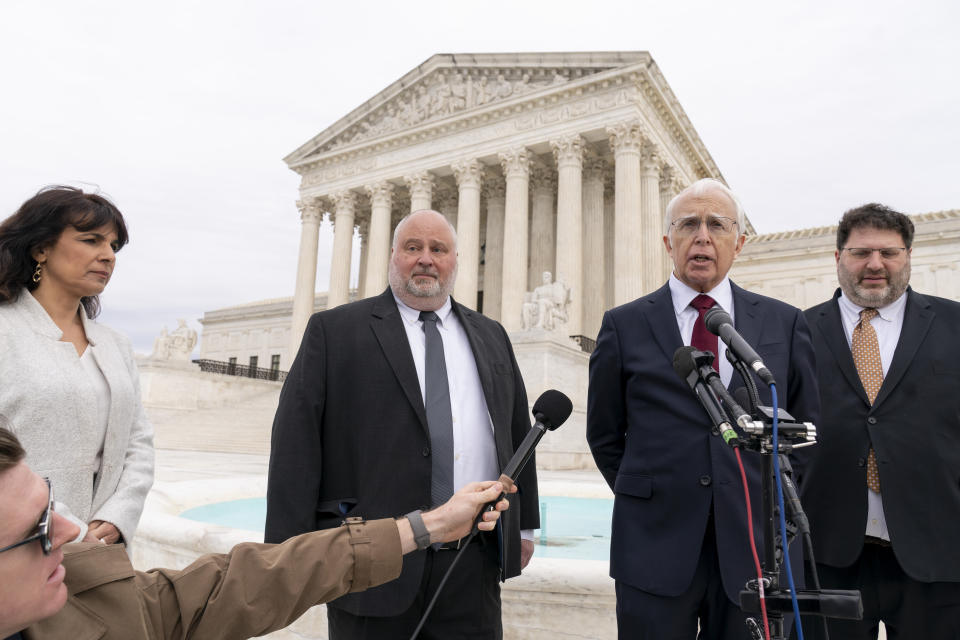 Attorney Eric Schnapper, second from right, accompanied by from left, Israeli attorney Nitsana Darshan-Leitner, attorney Keith Altman, Schnapper, and attorney Robert Tolchin, speaks to members of the media, Wednesday, Feb. 22, 2023, in Washington, after the Supreme Court heard oral arguments. The Supreme Court is weighing Wednesday whether Facebook, Twitter and YouTube can be sued over a 2017 Islamic State group attack on a Turkish nightclub based on the argument the platforms assisted in fueling the growth of the terrorist organization. (AP Photo/Andrew Harnik)