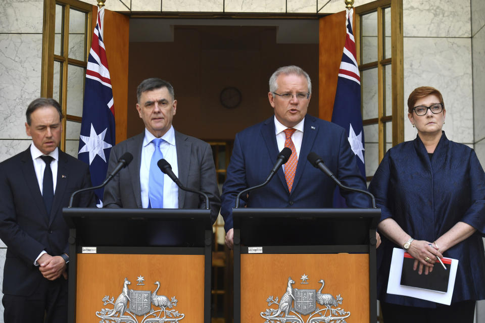 Australian Prime Minister Scott Morrison, second right, Minister for Health Greg Hunt, left, Chief Medical Officer Professor Brendan Murphy, and Minister for Foreign Affairs Marise Payne, right, give an update on the coronavirus at a press conference at Parliament House in Canberra, Wednesday, Jan. 29, 2020. Australia and New Zealand will work together to evacuate their isolated and vulnerable citizens from China's virus-hit Hubei province. (Mick Tsikas/AAP Image via AP)