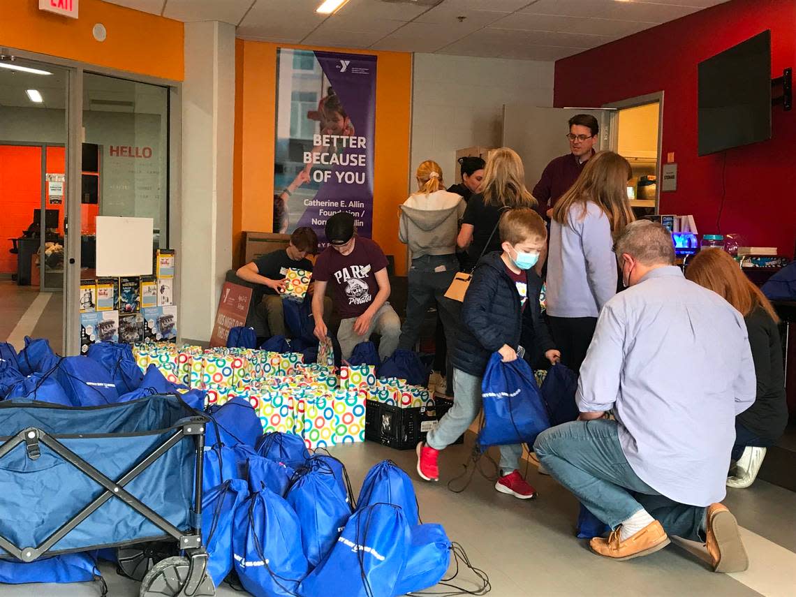 Volunteers at the Linwood YMCA fill care packages for people experiencing homelessness. Items include sandwiches, socks, toiletry items and homemade affirmation cards.