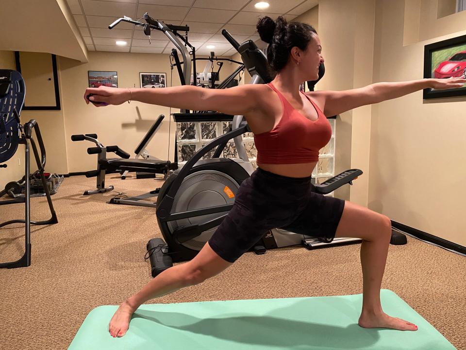 Fabiana practices yoga with a warrior pose.