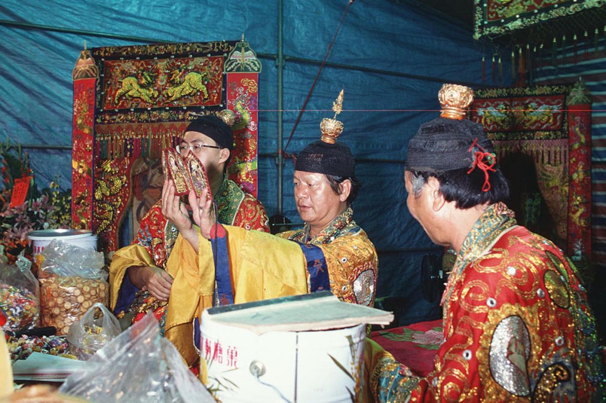 <span class="caption">Priests in Taiwan perform a ritual for the souls of the dead.</span> <span class="attribution"><a class="link " href="https://www.gettyimages.com/detail/news-photo/head-taoist-priest-mr-lai-and-fellow-priests-perform-a-news-photo/158684153?adppopup=true" rel="nofollow noopener" target="_blank" data-ylk="slk:Alberto Buzzola/LightRocket via Getty Images;elm:context_link;itc:0;sec:content-canvas">Alberto Buzzola/LightRocket via Getty Images</a></span>