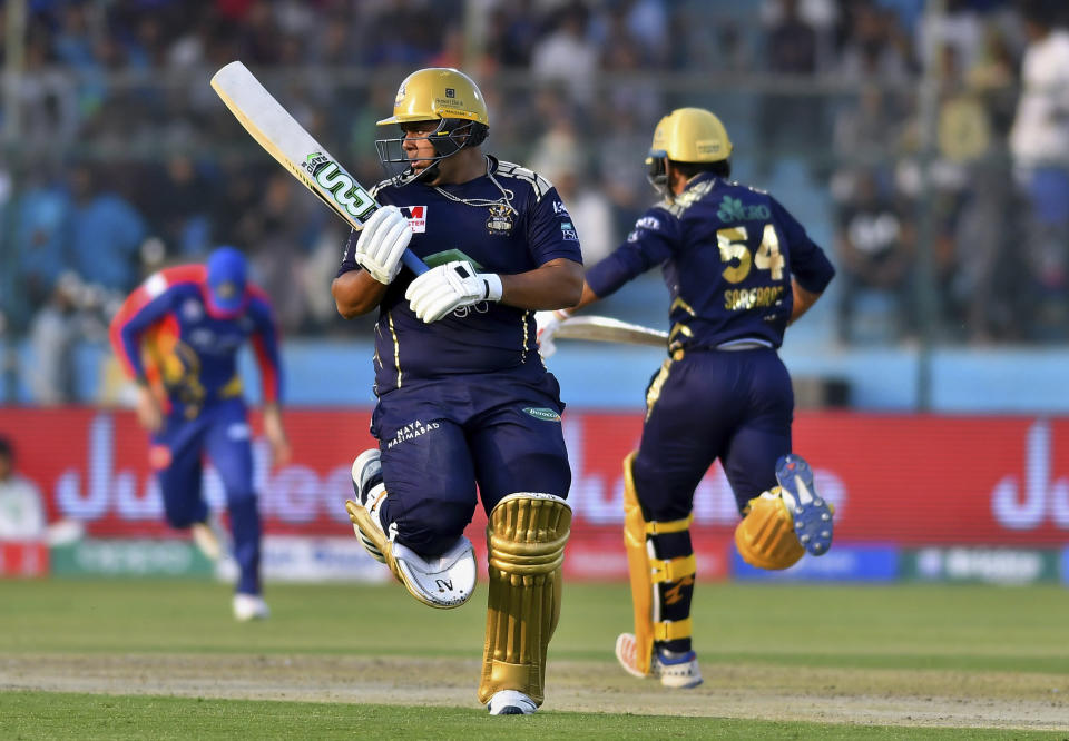 Quetta Gladiators batsmenn Azam Khan, left, and Sarfraz Ahmed take a run during the Pakistan Super League T20 cricket match against Karachi Kings at National Stadium in Karachi, Pakistan, Sunday, Feb. 23, 2020. (AP Photo/Fareed Khan)