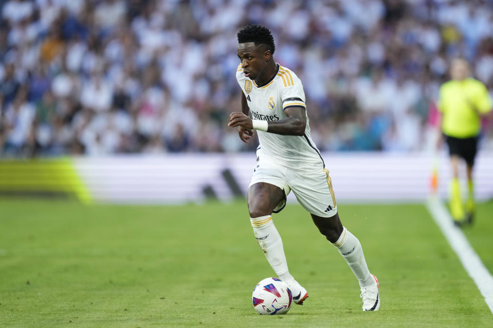 Real Madrid's Vinicius Junior in action during the Spanish La Liga soccer match between Real Madrid and Osasuna at the Santiago Bernabéu stadium in Madrid, Spain, Saturday, Oct. 7, 2023. (AP Photo/Jose Breton)