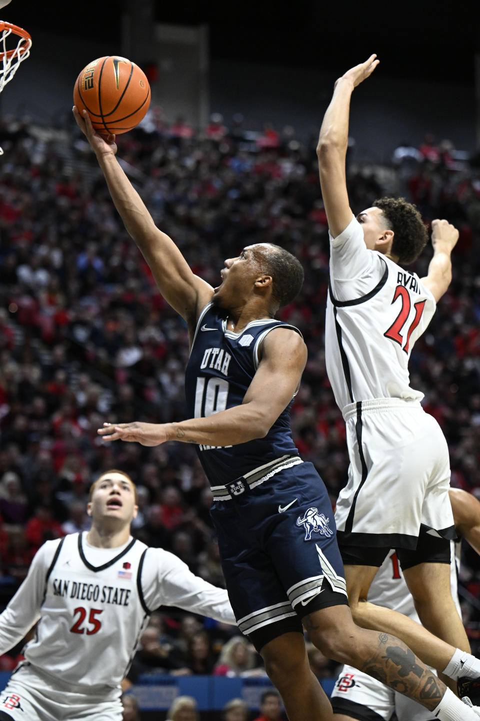 Utah State guard Darius Brown II (10) shoots ahead of San Diego State guard Miles Byrd (21) during the first half of an NCAA college basketball game, Saturday, Feb. 3, 2024, in San Diego. (AP Photo/Denis Poroy)