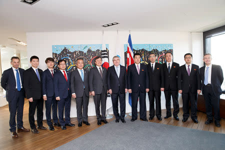 International Olympic Committee (IOC) President Thomas Bach, Korean Sports Minister Do Jong-hwan, and North Korea's Olympic Committee President and Minister of Physical Culture and Sports Kim Il Guk, with their delegations pose for the photographers, prior a meeting with the IOC for their bid to co-host the 2032 Summer Olympics, at the IOC Headquarters in Lausanne, Switzerland, Friday, February 15, 2019. Salvatore Di Nolfi/Pool via REUTERS