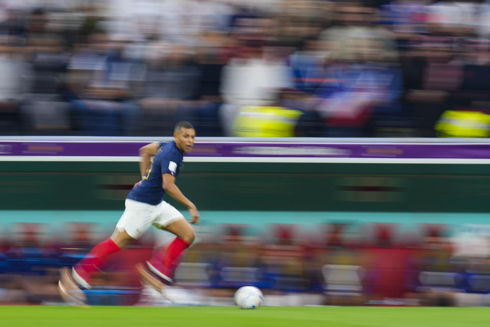 France's Kylian Mbappe runs with the ball during the World Cup quarterfinal soccer match between England and France, at the Al Bayt Stadium in Al Khor, Qatar, Saturday, Dec. 10, 2022. (AP Photo/Natacha Pisarenko)