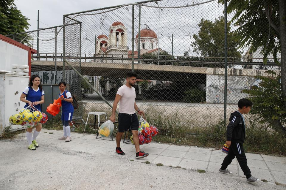 In this Wednesday, May 22, 2019 photo, members of Hestia FC Women's Refugee Soccer team prepare for a training session in Athens. Many of the players at Hestia FC weren't allowed to play or even watch soccer matches in their home countries. Hestia FC was set up by the Olympic Truce Centre, a non-government organization created in 2000 by the International Olympic Committee and Greek Foreign Ministry. (AP Photo/Thanassis Stavrakis)