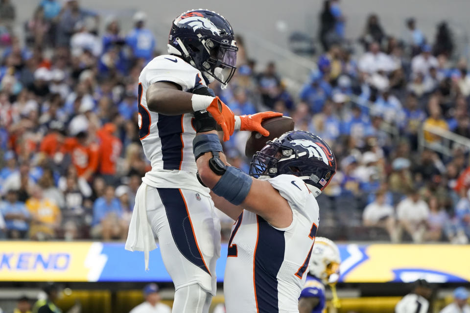 Denver Broncos running back Javonte Williams, left, and offensive tackle Garett Bolles celebrate a touchdown by Williams during the first half of an NFL football game against the Los Angeles Chargers Sunday, Dec. 10, 2023, in Inglewood, Calif. (AP Photo/Marcio Jose Sanchez)