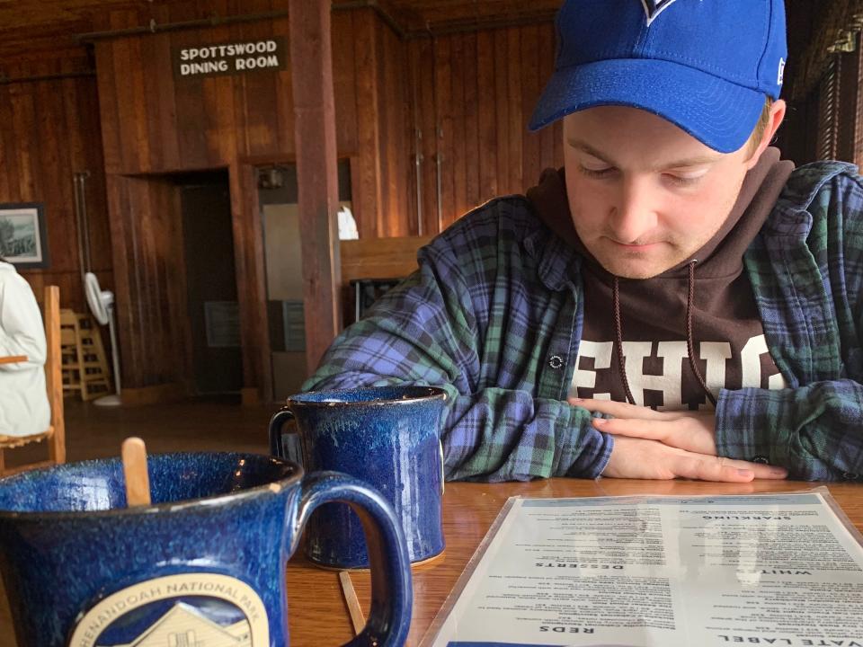 man looks at menu in Big Meadows Lodge at Shenandoah National Park