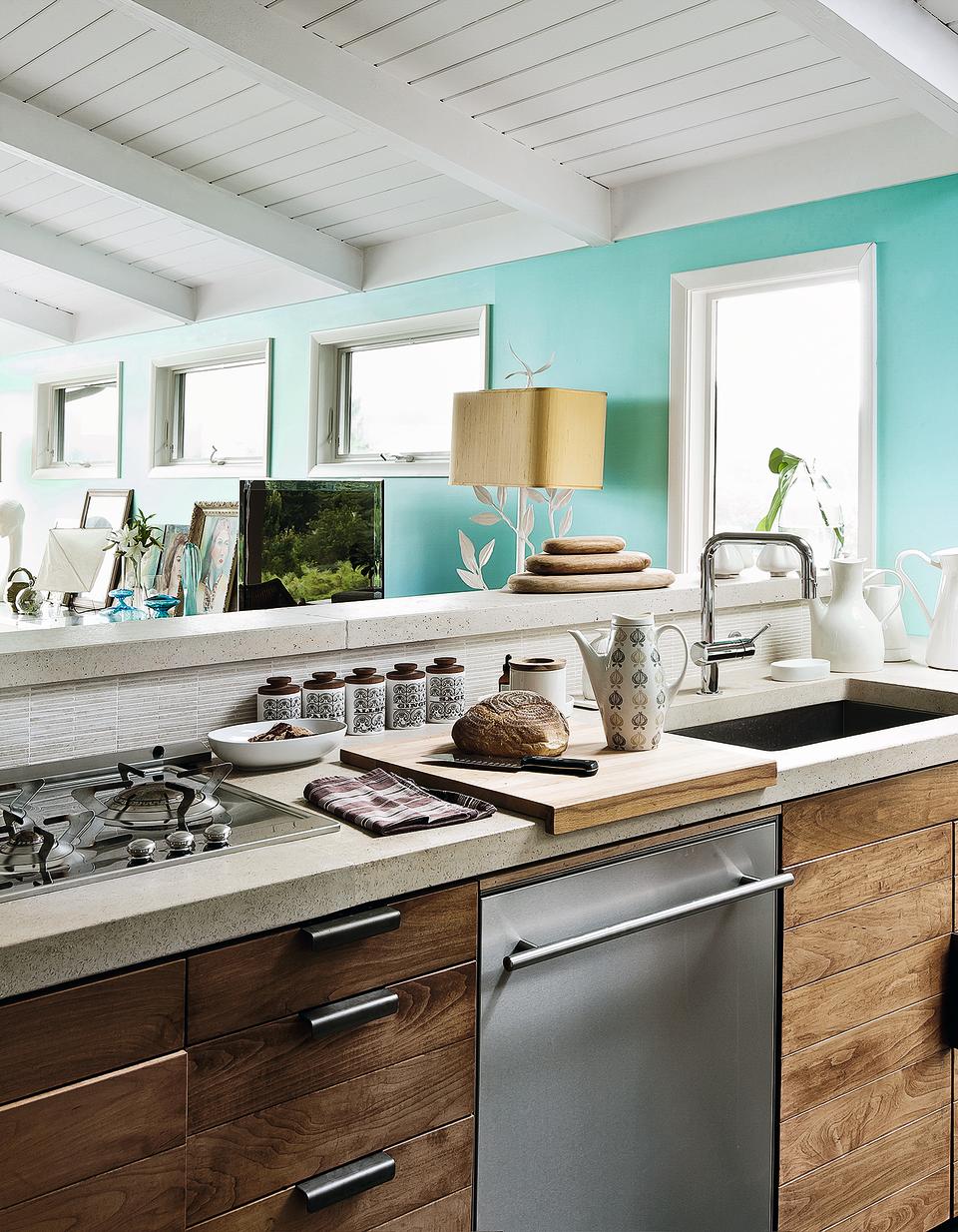 A kitchen with beige granite counter