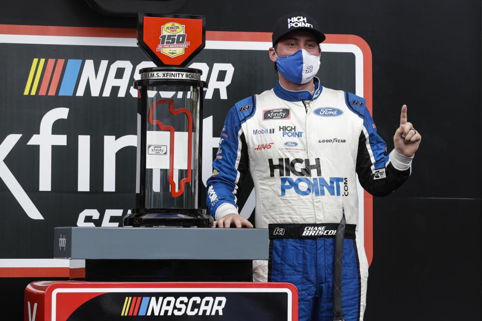 NASCAR Xfinity Series driver Chase Briscoe poses with the trophy after winning the NASCAR Xfinity Series auto race at Indianapolis Motor Speedway in Indianapolis, Saturday, July 4, 2020. (AP Photo/Darron Cummings)