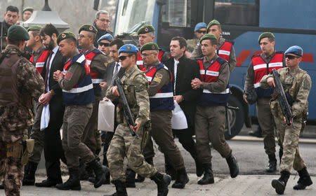 Turkish soldiers accused of attempting to assassinate President Tayyip Erdogan on the night of the failed last year's July 15 coup, are escorted by gendarmes as they arrive for the first hearing of the trial in Mugla, Turkey, February 20, 2017. REUTERS/Kenan Gurbuz