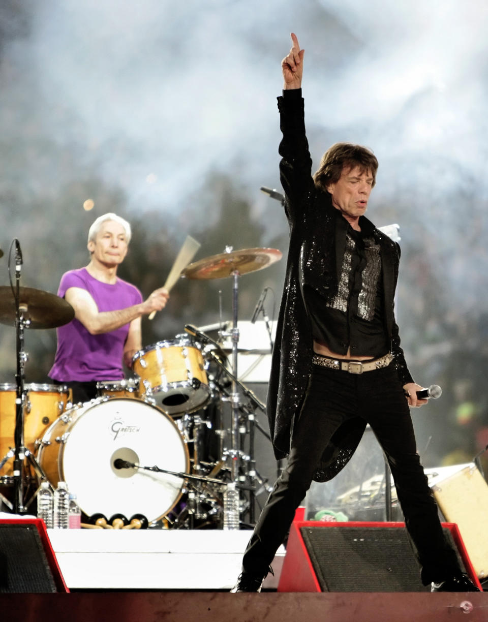 FILE - Mick Jagger, right, and drummer Charlie Watts, perform with the Rolling Stones at halftime of the Super Bowl XL football game in Detroit on Feb. 5, 2006. Watts' publicist, Bernard Doherty, said Watts passed away peacefully in a London hospital surrounded by his family on Tuesday, Aug. 24, 2021. He was 80. (AP Photo/David J. Phillip, File)