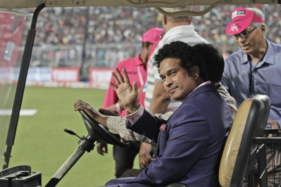 Former Indian cricketer Sachin Tendulkar acknowledges the crowd during a grand parade of India's former cricket captains during the first day of the second test match between India and Bangladesh, in Kolkata, India, Friday, Nov. 22, 2019. (AP Photo/Bikas Das)