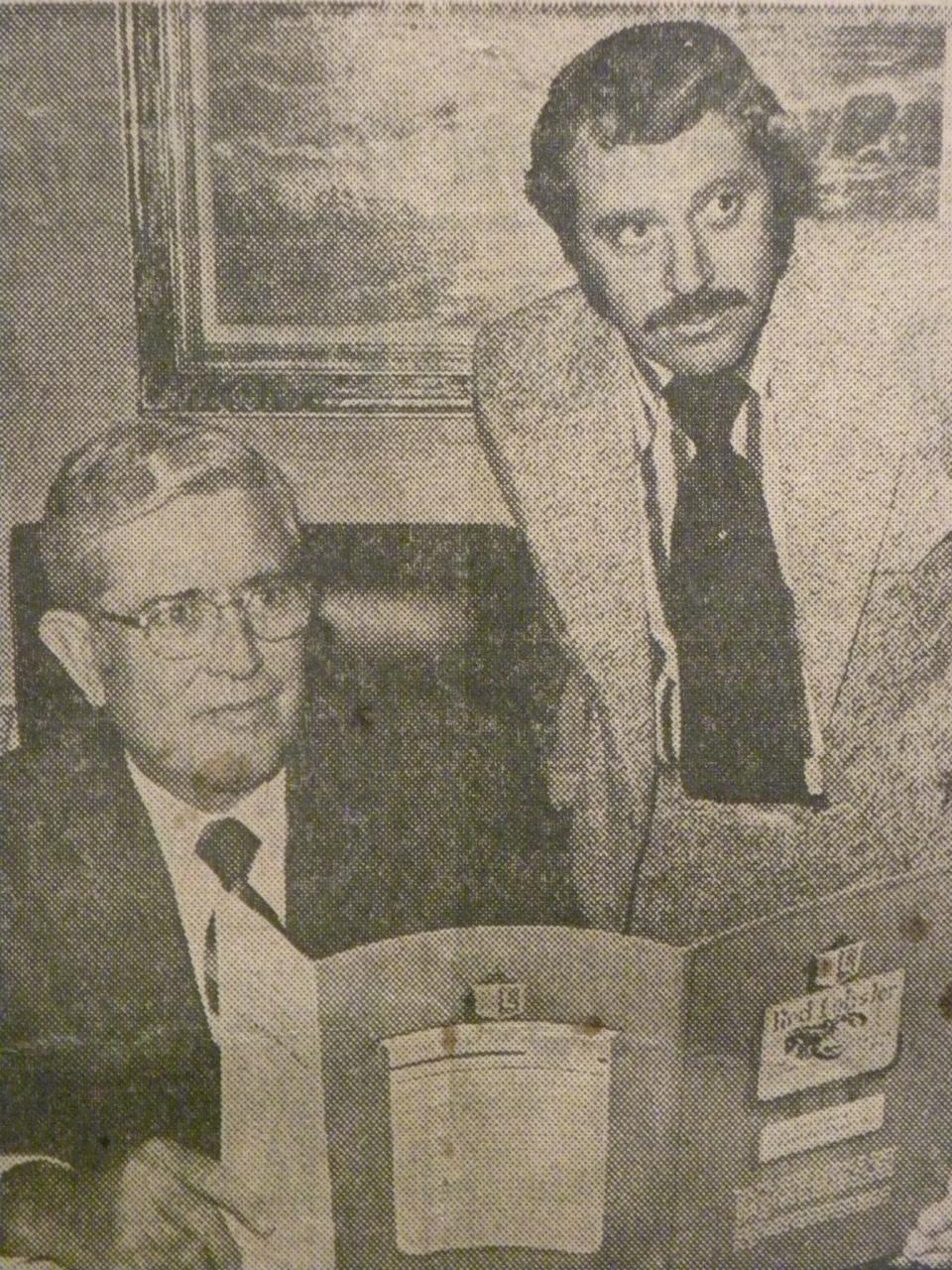 Charley Woodsby and William Darden with a Red Lobster menu in the early days of the eatery.