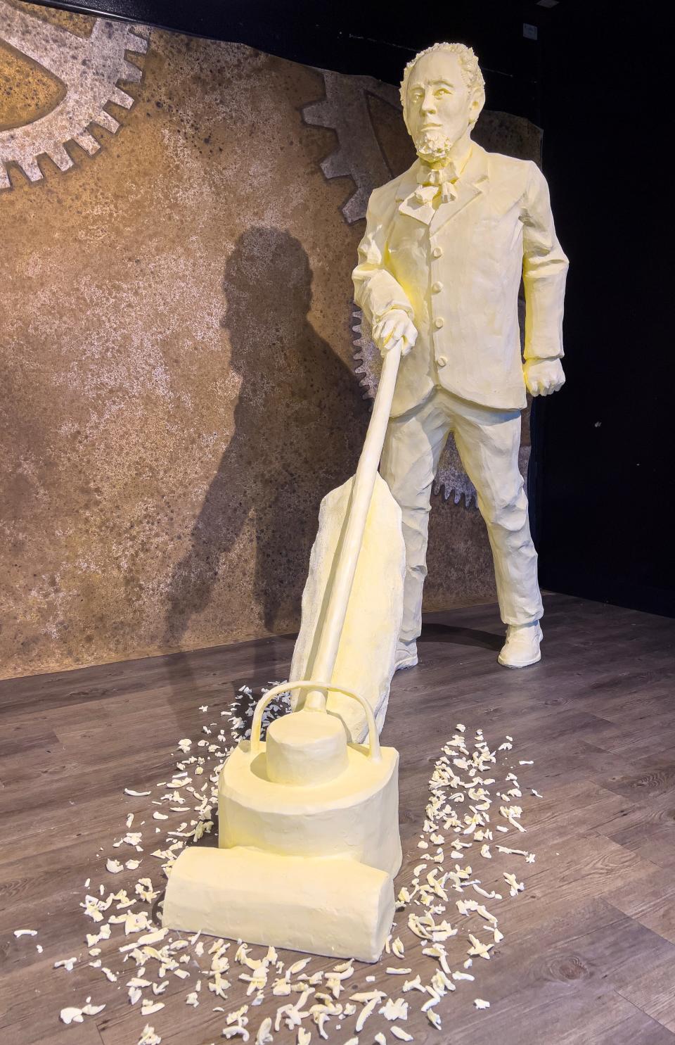 James Spangler and the first electric portable vacuum cleaner are sculpted in butter at this year’s butter cow display at the Ohio State Fair. Spangler invented the vacuum cleaner while working as a janitor in Canton.