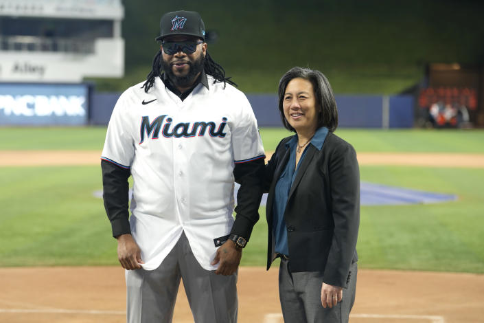 Pitcher Johnny Cueto, left, poses for a photograph with Miami Marlins General Manager Kim Ng, after signing a contract with the Miami Marlins baseball team, Thursday, Jan. 19, 2023, in Miami. Cueto signed a one-year contract with the Marlins with a club option for 2024. (AP Photo/Lynne Sladky)