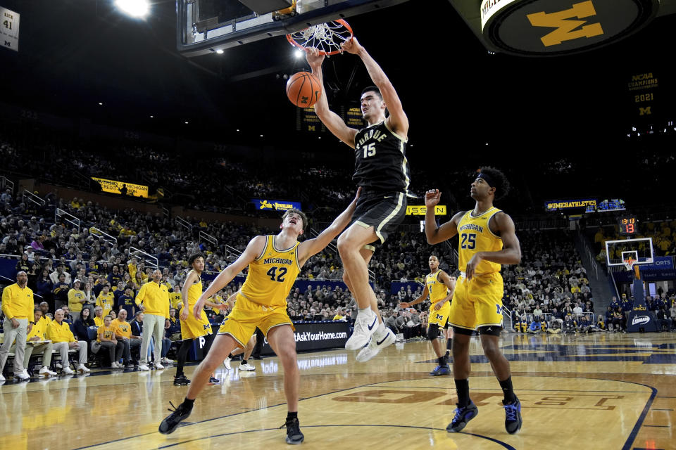 Purdue center Zach Edey (15) dunks on Michigan forward Will Tschetter (42) in the first half of an NCAA college basketball game in Ann Arbor, Mich., Sunday, Feb. 25, 2024. (AP Photo/Paul Sancya)