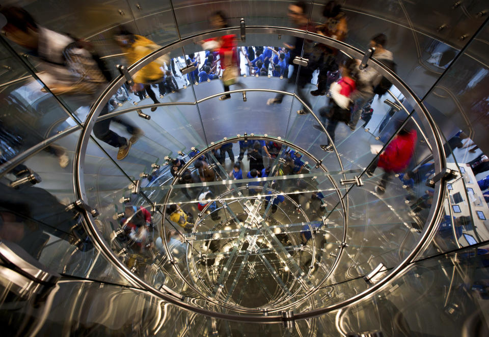 FILE-In this Saturday, Oct. 20, 2012, file photo, Customers walk spiral steps of a newly-opened Apple Store in Wangfujing shopping district in Beijing. Apple missed Wall Street earnings expectations for the second straight quarter, as iPad sales fell short of analyst forecasts.The slowdown in the growth of iPad sales was not unexpected, as the rumour mill correctly predicted that Apple would launch a smaller, cheaper iPad. It announced that device, the iPad Mini, on Tuesday, Oct. 23. (AP Photo/Andy Wong)