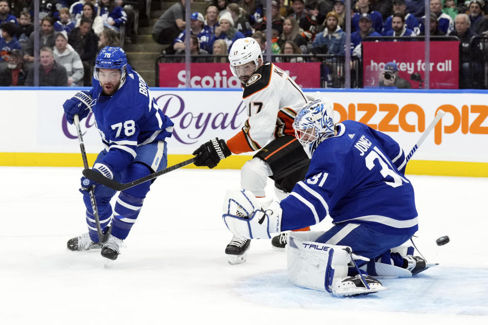 Toronto Maple Leafs goaltender Martin Jones, TJ Brodie, left, and Anaheim Ducks' Alex Killorn watch the puck go wide of the goal during the first period of an NHL hockey game, Saturday, Feb. 17, 2024 in Toronto. (Chris Young/The Canadian Press via AP)