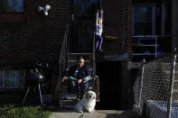 Allison, 5, plays, as her mother Janeth sits outside their basement apartment unit with the family dog, Henry, Wednesday, April 15, 2020, in Washington. Since this image was taken Janeth and her husband Roberto have been diagnosed with COVID-19. (AP Photo/Jacquelyn Martin)