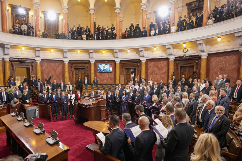 Serbia's new Prime Minister Milos Vucevic and ministers of the new government of Serbia read their oaths at the parliament session during her cabinet's swearing in ceremony at the Serbian Parliament building in Belgrade, Serbia, Thursday, May 2, 2024. Serbian lawmakers on Thursday voted into office a new government that reinstated two pro-Russia officials who are sanctioned by the United States, reflecting persistent close ties with Moscow despite the Balkan nation's proclaimed bid to join the European Union. (AP Photo/Darko Vojinovic)