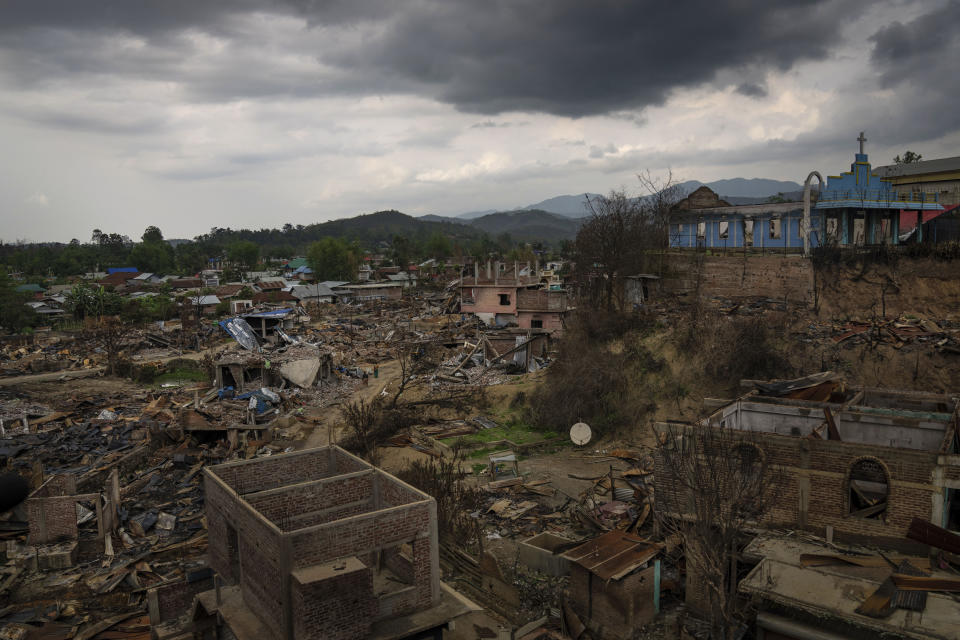 Dozens of houses are seen vandalised and burnt following ethnic clashes and rioting in Sugnu, in the northeastern Indian state of Manipur, Wednesday, June 21, 2023. The deadly clashes between two ethnic communities, which have left at least 120 dead by the authorities' conservative estimates, persist despite the army’s presence. Isolated villages are still raked with gunfire. Burnt buildings and churches stare out at the narrow dirt roads. In front-line neighborhoods, women join night patrols with flaming torches. (AP Photo/Altaf Qadri)