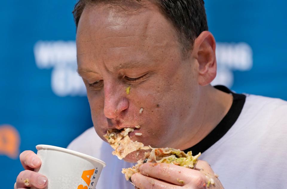 Joey Chestnut digs into a burrito during the World Burrito Eating Contest.