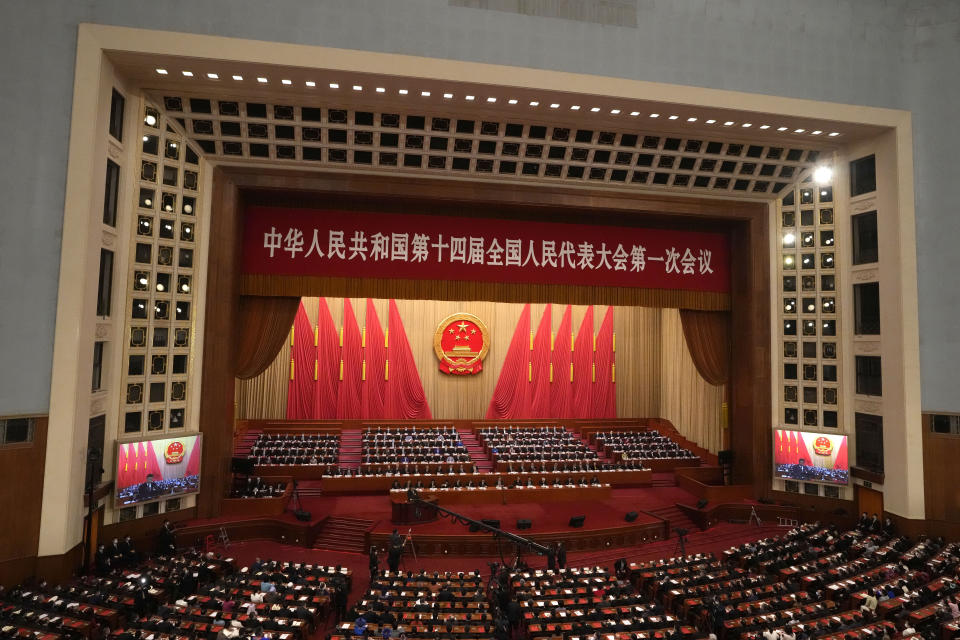 FILE - Delegates attend the closing ceremony for China's National People's Congress (NPC) as Chinese President Xi Jinping delivers a speech at the Great Hall of the People in Beijing, Monday, March 13, 2023. This year's National People's Congress annual meeting, which opens Tuesday, is being closely watched for any signals on what the ruling Communist Party might do to re-energize an economy that is sagging under the weight of expanded government controls and the bursting of a real-estate bubble. (AP Photo/Andy Wong, File)