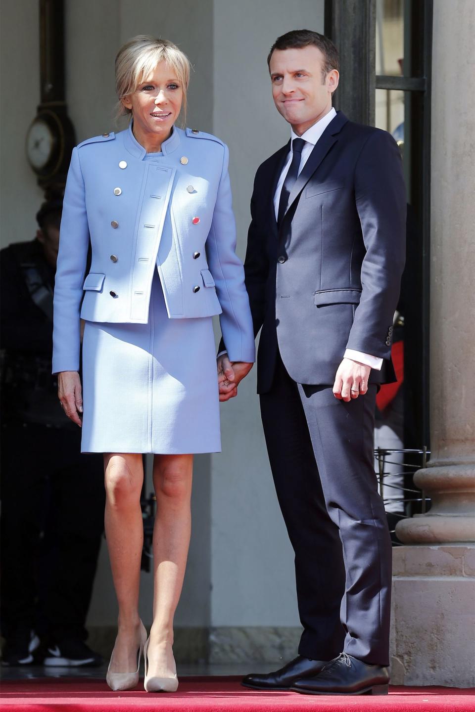 <p>In a light blue skirt suit and nude heels with her husband on the on the steps of the Elysee Palace in Paris, France.</p>