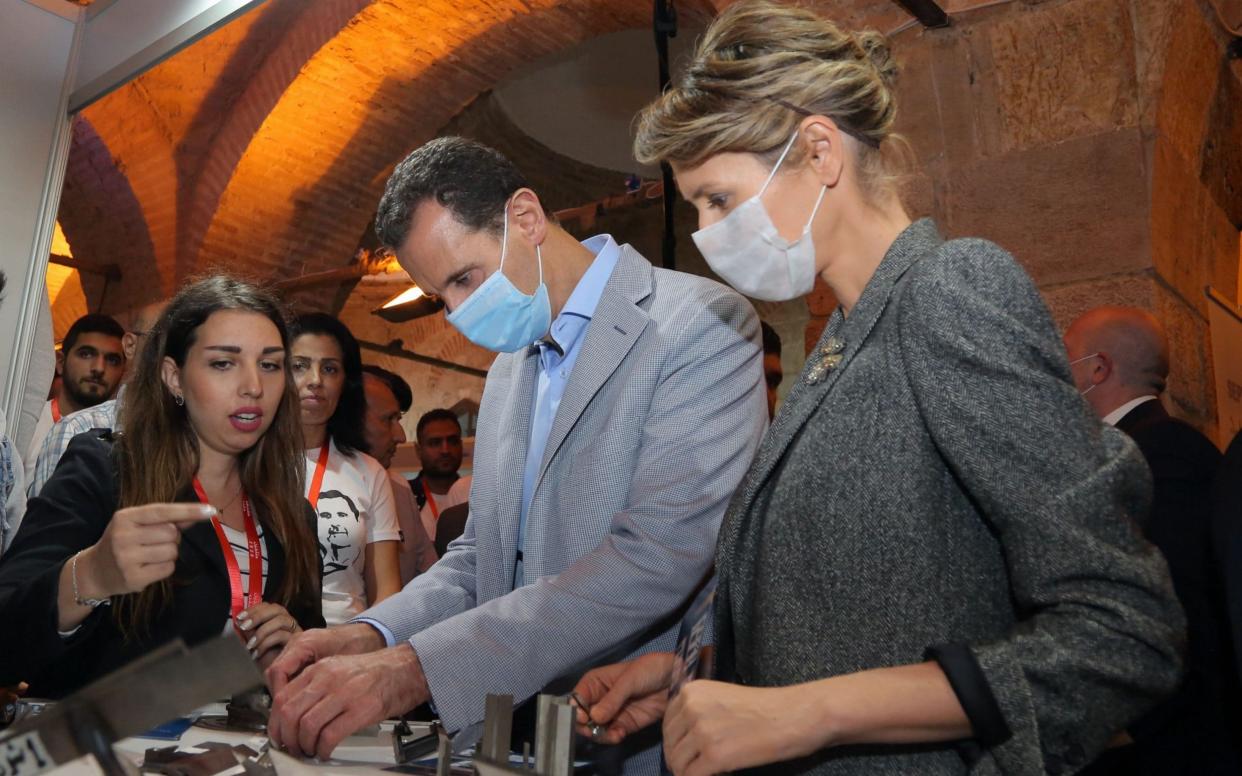 Syrian President Bashar al-Assad and his wife Asma Assad wear face masks during a tour of Damascus - Shutterstock/Shutterstock