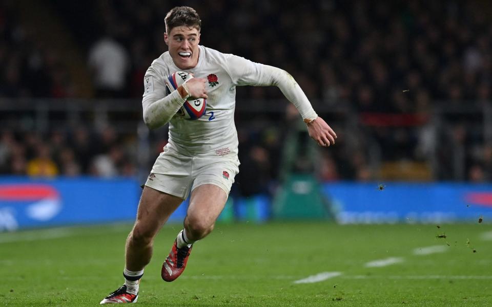 England's wing Tommy Freeman runs with the ball during the Six Nations international rugby union match between England and Wales at Twickenham