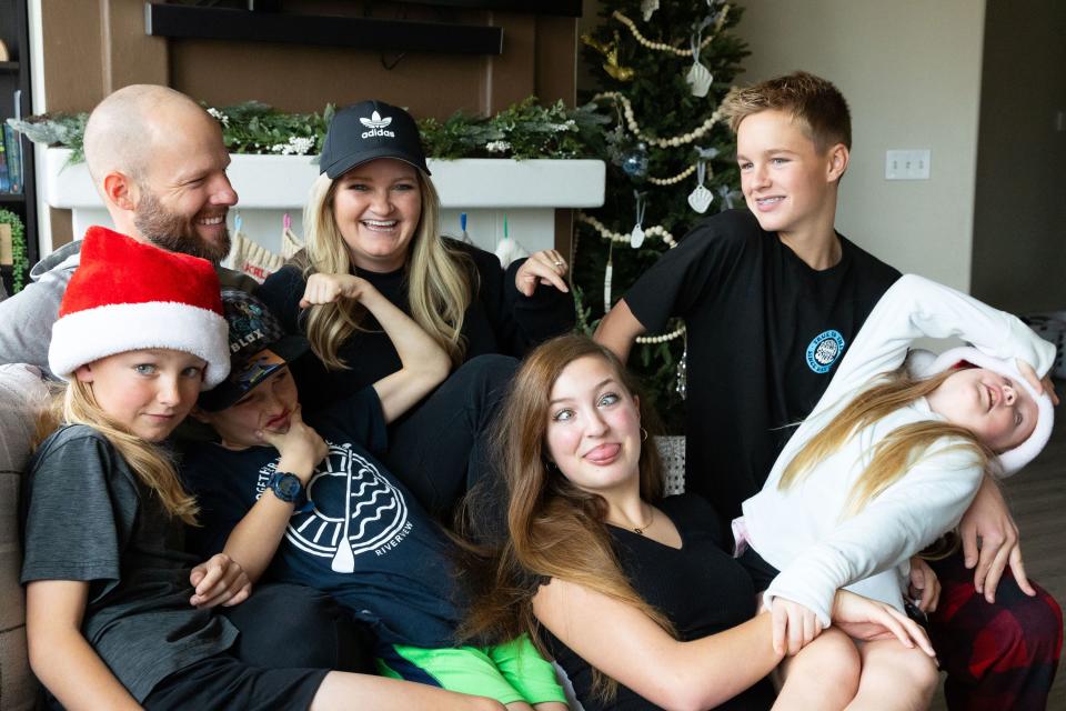 The Priday family, clockwise from top left, Darin, Kali, Deacon, 13, Zoe, 8, Kylie, 15, Zeke, 8, Jaxon, 10, make funny faces for a portrait at their home in Saratoga Springs on Sunday, Dec. 3, 2023. | Megan Nielsen, Deseret News