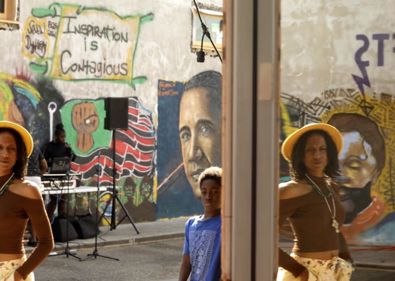 LOS ANGELES, CA - SEPTEMBER 25, 2021 - - People enjoy the, "Black To The Future," tech event in the business district of Leimert Park on September 25, 2021. The event was highlighting Black technology through a speakers forums and other venues to share the latest technology created by Black techs. Home sales are soaring in Leimert Park causing fear that the residents can no longer afford to buy homes in the neighborhood. (Genaro Molina / Los Angeles Times)