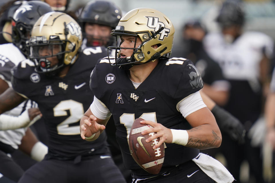 Central Florida quarterback Dillon Gabriel looks for a receiver against Cincinnati during the first half of an NCAA college football game, Saturday, Nov. 21, 2020, in Orlando, Fla. (AP Photo/John Raoux)