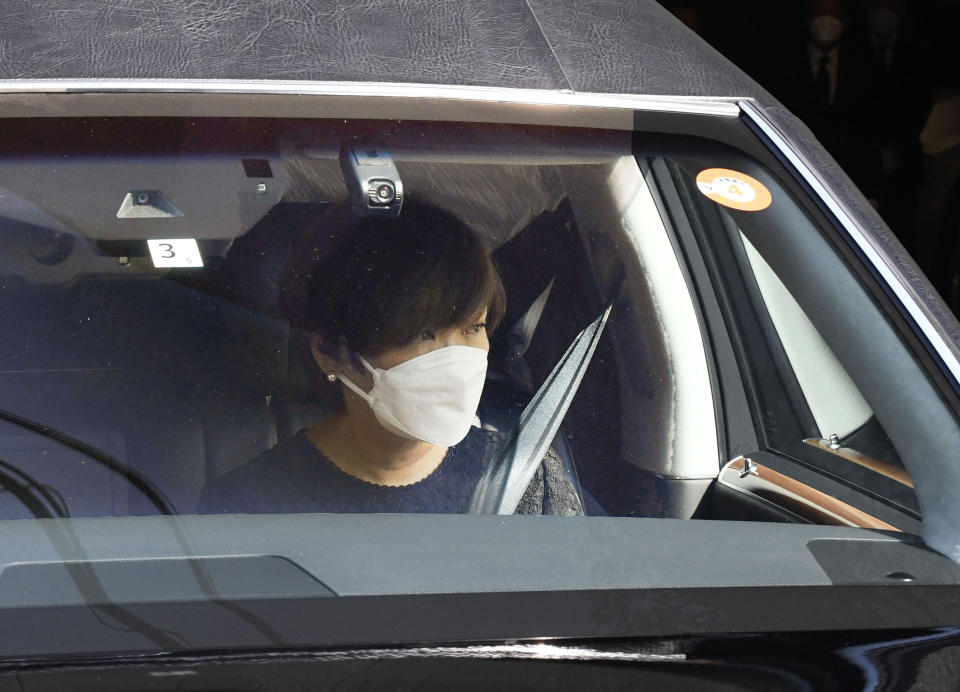 Akie Abe, wife of Japan's former Prime Minister Shinzo Abe, is seen in the hearse carrying Abe's body as they leave their residence for Zojoji temple for the funeral wake in Tokyo, Japan, Monday, July 11, 2022. (Junko Ozaki/Kyodo News via AP)