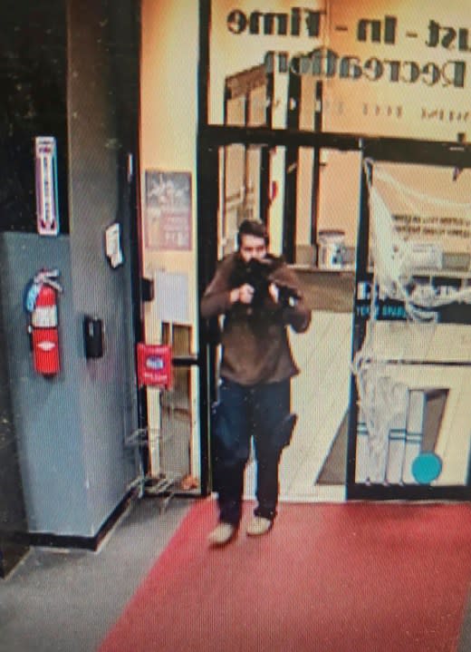 In this image taken from video released by the Androscoggin County Sheriff’s Office, an unidentified gunman points a gun while entering Sparetime Recreation in Lewiston, Maine, on Wednesday, Oct. 25, 2023. Maine State Police ordered residents in the state’s second-largest city to shelter in place Wednesday night as the suspect remains at large. (Androscoggin County Sheriff’s Office via AP)
