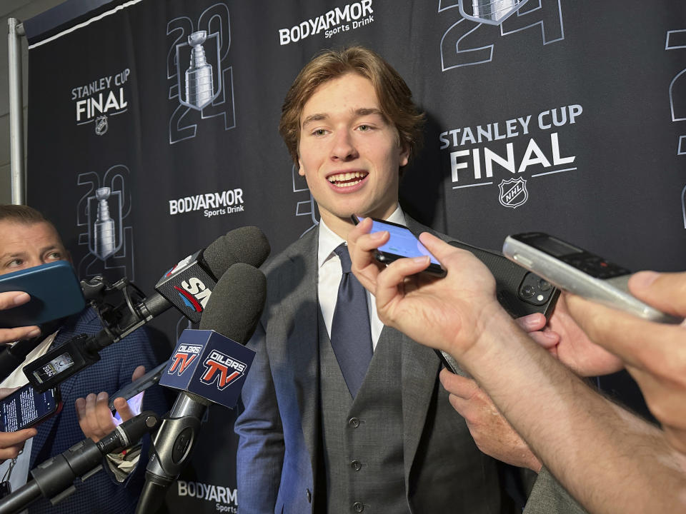 FILE - Macklin Celebrini, the expected No. 1 pick in the NHL draft to the San Jose Sharks, speaks with reporters prior to Game 2 of the Stanley Cup Final at Amerant Bank Arena in Sunrise, Florida, Monday, June 10, 2024. Celebrini sets aside his NBA ties by looking ahead to a hockey career, entering the NHL draft as the presumptive No. 1 pick on Friday, June 28. (AP Photo/Stephen Whyno, File)