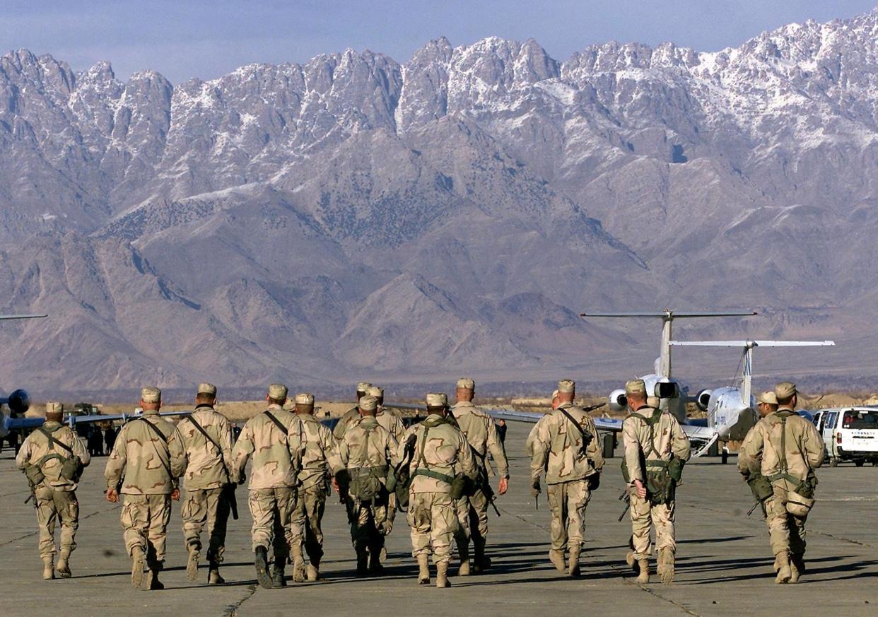 American soldiers approach UN planes on the tarmac of Bagram airbase on 15 January 2002 in this file photo (AFP via Getty Images)