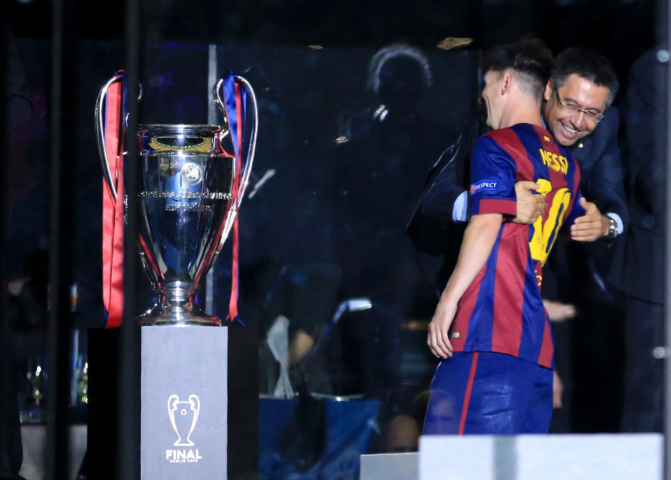 Barcelona's president Josep Maria Bartomeu celebrates with Lionel Messi before the trophy presentation