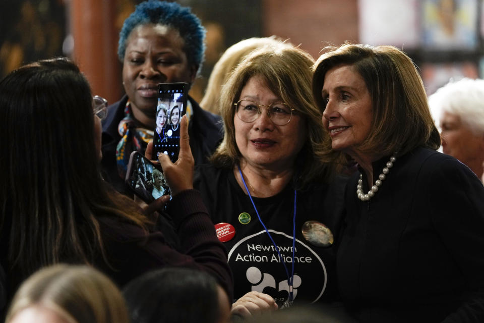 House Speaker Nancy Pelosi of Calif., poses for photos before President Joe Biden speaks during an event in Washington, Wednesday, Dec. 7, 2022, with survivors and families impacted by gun violence for the 10th Annual National Vigil for All Victims of Gun Violence. (AP Photo/Susan Walsh)