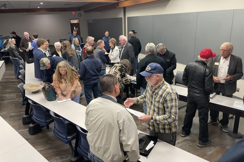 Attendees converge on the panelists at the end of a public forum on property taxes April 20, 2024, at South Dakota Mines in Rapid City. (Seth Tupper/South Dakota Searchlight)