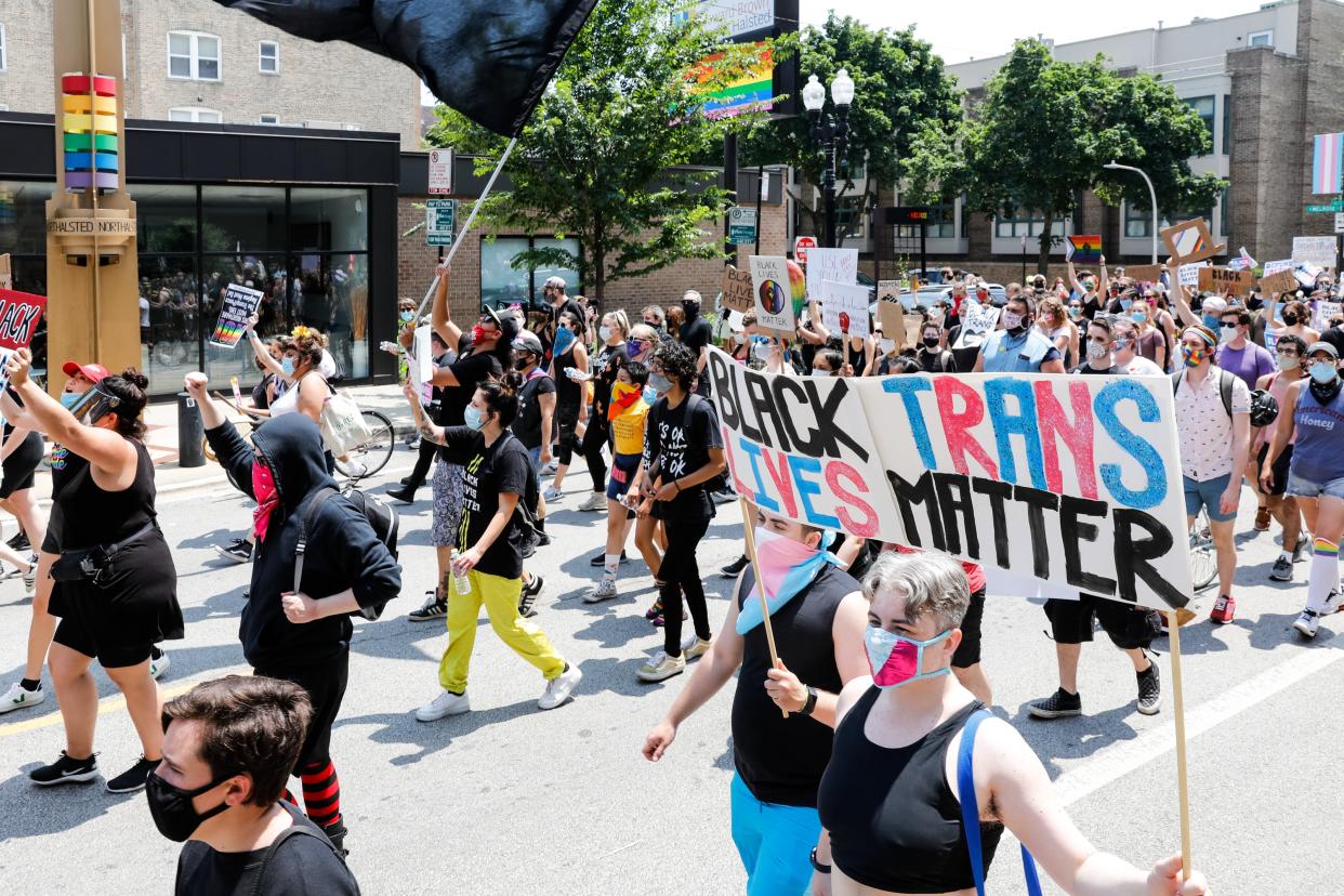 Protesters hold signs during the Pride Without Prejudice march in Boystown on 28 June 2020 in Chicago, Illinois. Demonstrators gathered to march for LGBT+ and Black Lives as protests continue across the nation ((Getty Images))