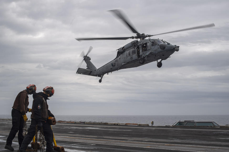 In this handout photo provided by the U.S. Navy, MH-60S Sea Hawk, assigned to the "Eightballers" of Helicopter Sea Combat Squadron (HSC) 8, lands on the flight deck of the Nimitz-class aircraft carrier USS Theodore Roosevelt (CVN 71) during exercise Freedom Edge, on Friday, June 28, 2024. The newly-inaugurated Freedom Edge exercise is wrapping up in the East China Sea, having brought together Japanese, South Korean and American naval assets for multi-domain maneuvers for the first time. (Mass Communication Specialist Seaman Aaron Haro Gonzalez/U.S. Navy via AP)